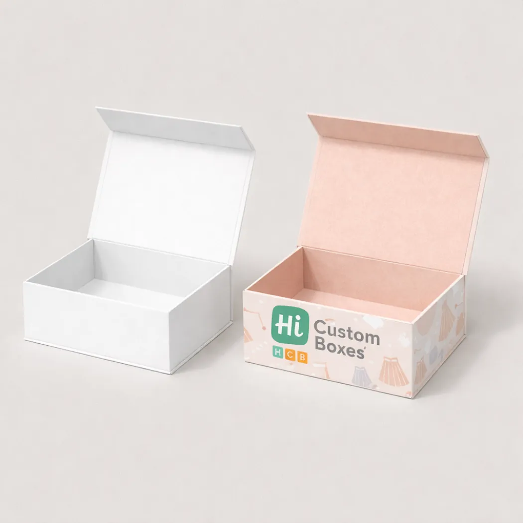 A pair of open rigid gift boxes- one in plain white and one with a pink illustrated pattern- class=